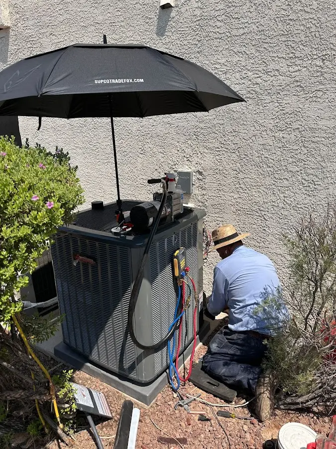 HVAC technician performing outdoor AC maintenance in Ben Lomond